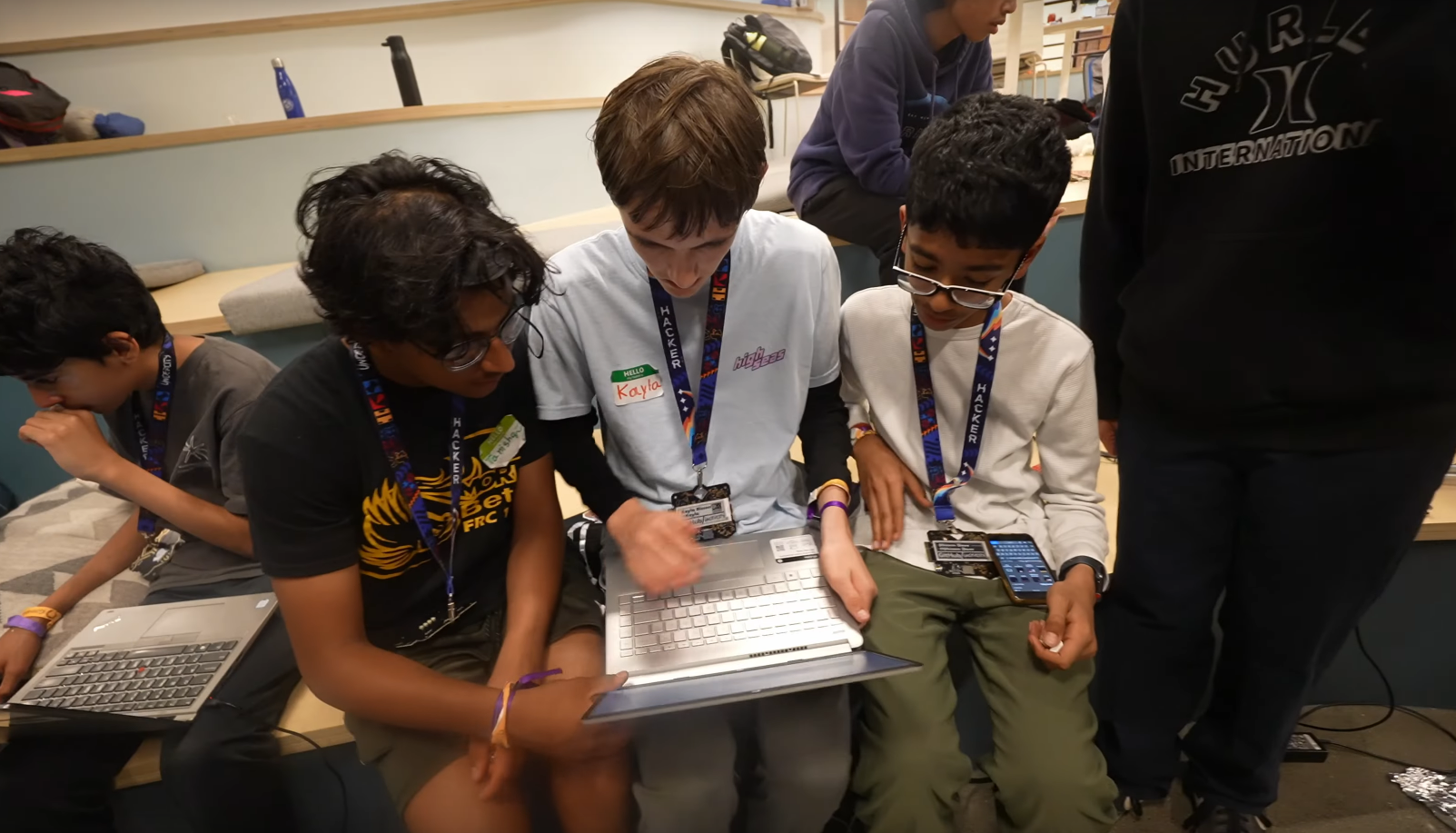 3 people looking at a laptop